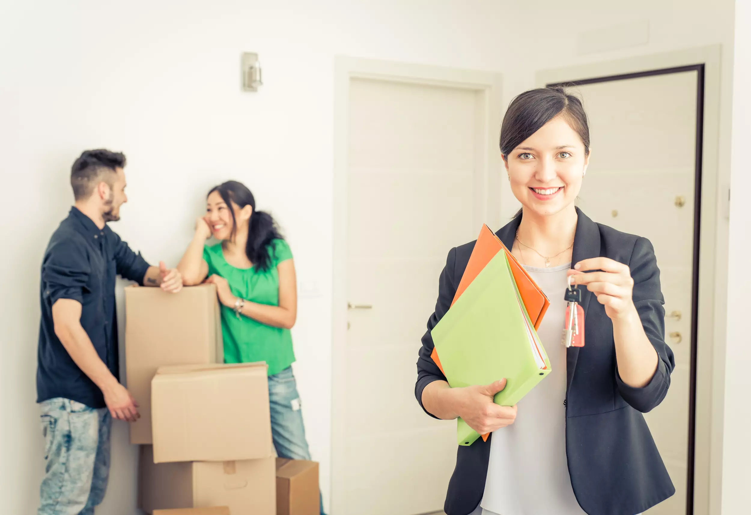 A realtor holding out keys to a new home